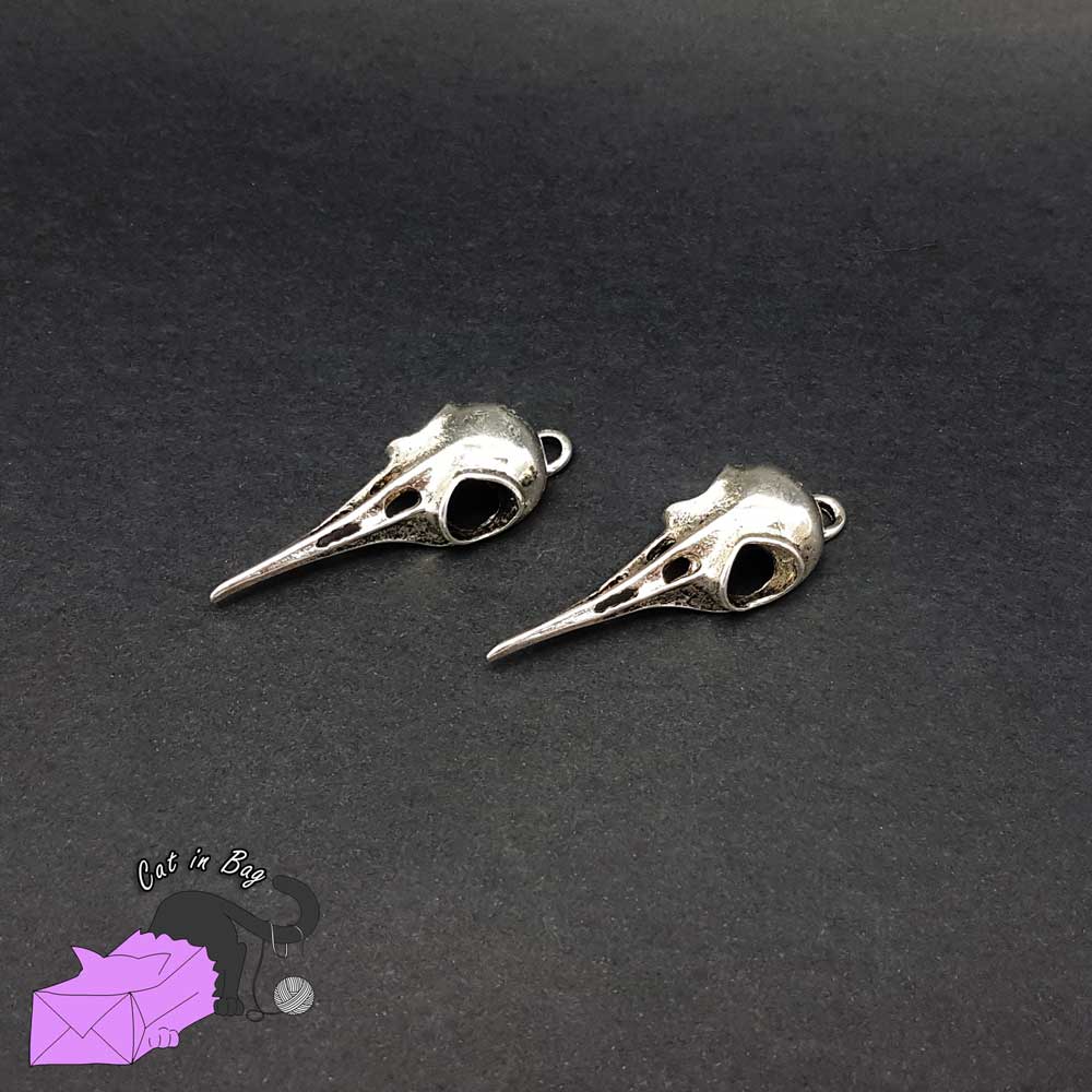 2 charms with crow skull