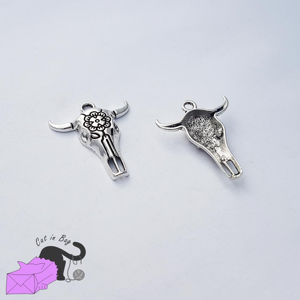 5 charms with cow skull